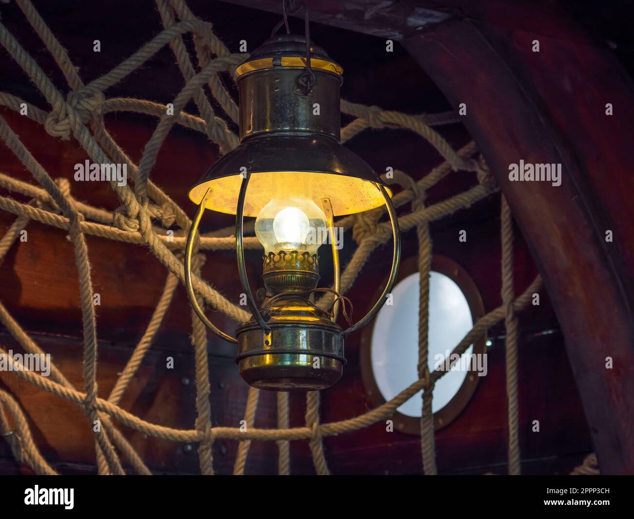 A vintage fishing boat with an old cabin interior lit by retro lighting equipment Stock Photo
