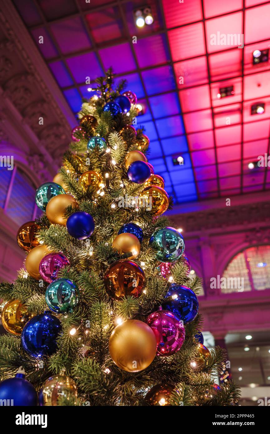 Christmas tree and New Year decorations in the interior of a colorful illuminated shopping hall