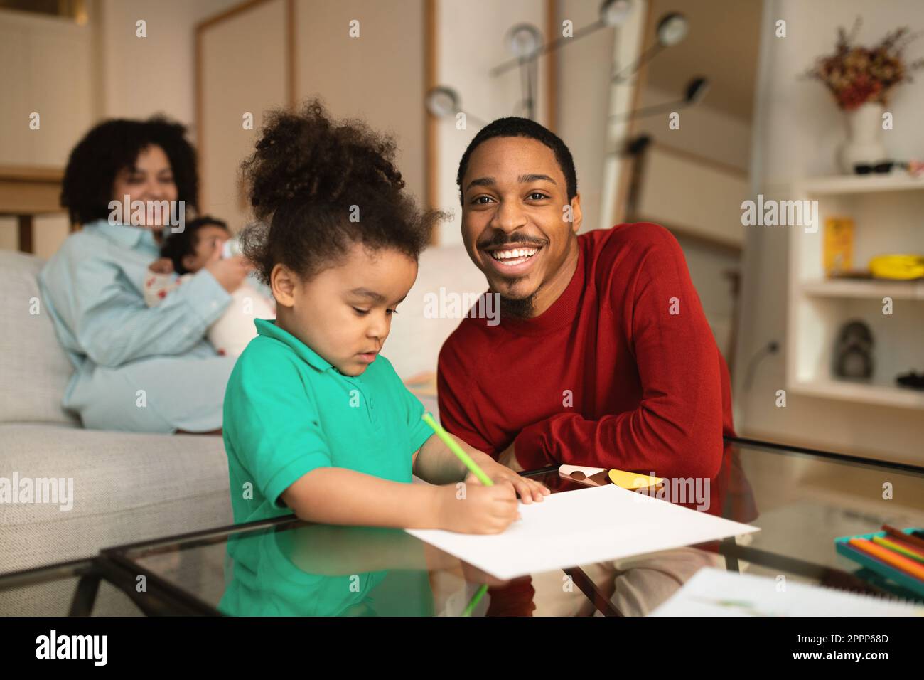 Happy black father spending time with his family at home Stock Photo ...