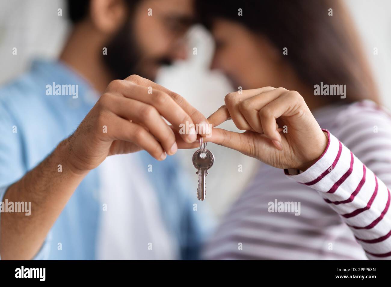Young couple hug at new home, holding house keys Stock Photo - Alamy