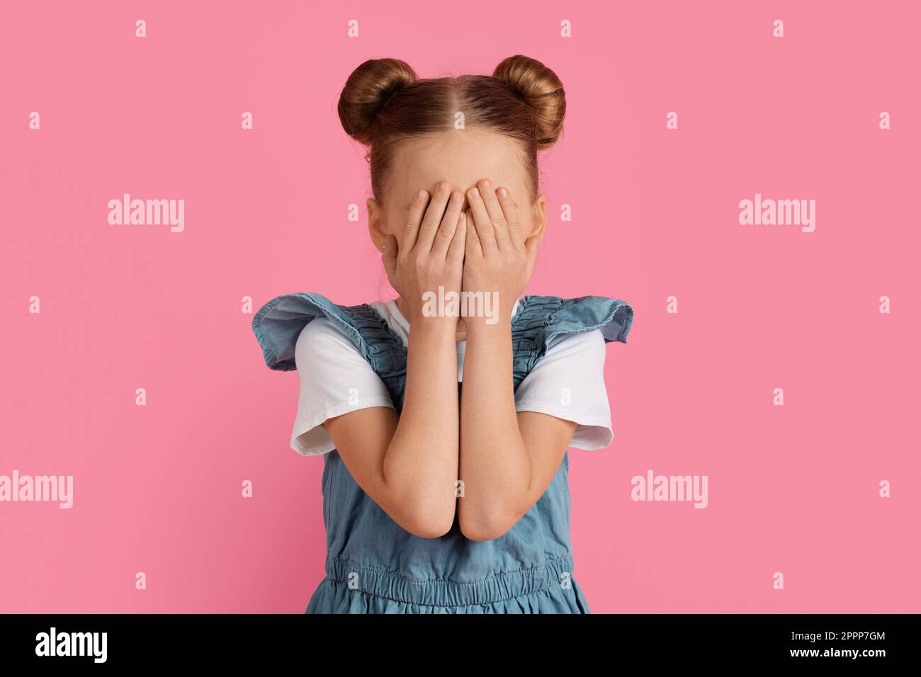Portrait of scared little girl covering her face with hands Stock Photo ...