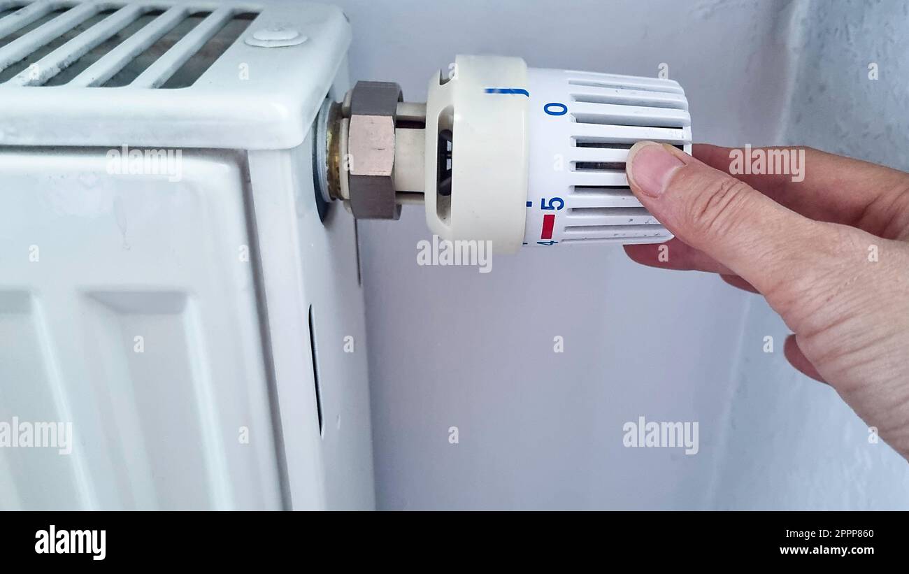 Hand adjustment of a heater to zero to reduce expenses. Saving energy