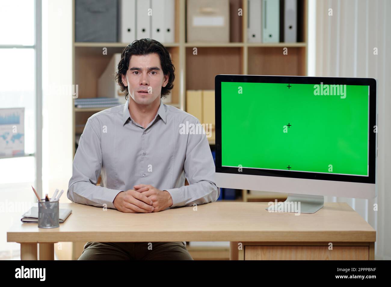 Serious and confident male broker or ceo making presentation while ...