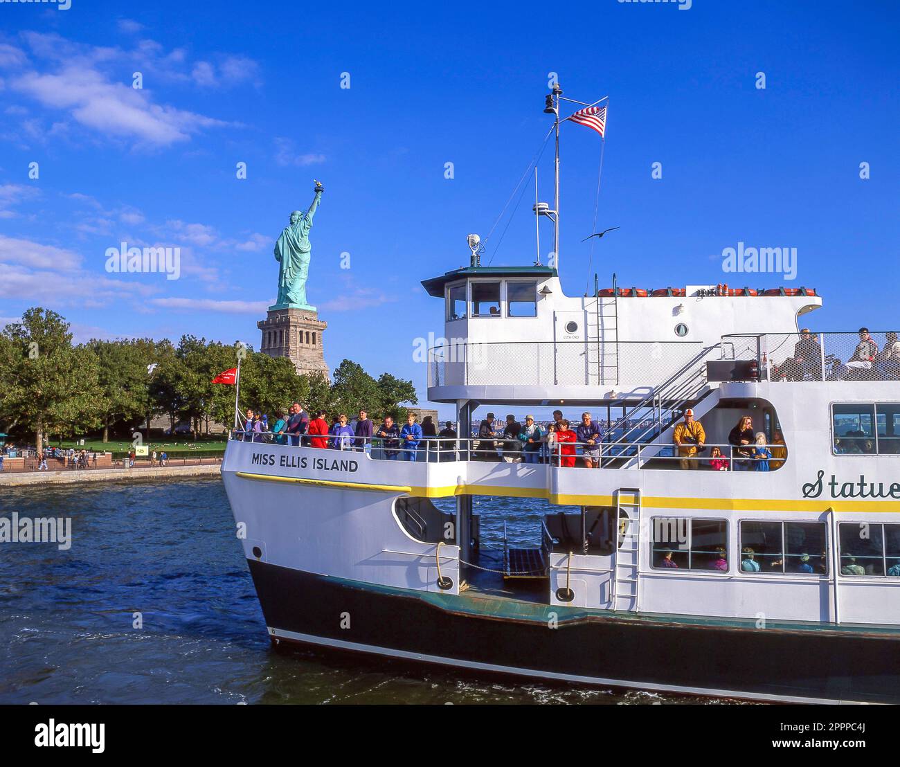 Miss Ellis Island Ferry passing Statue of Liberty National Monument, Liberty Island, New York, New York State, United States of America Stock Photo