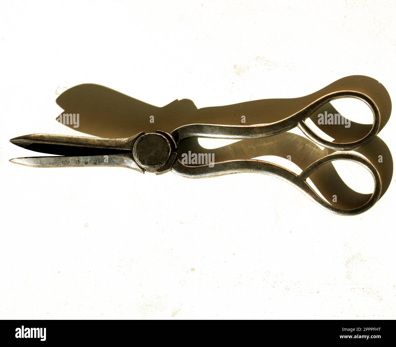 Old tarnished silver grape scissors. white background Stock Photo