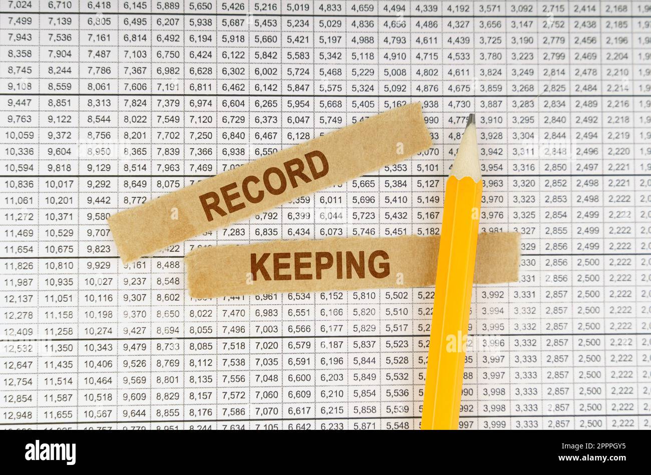 Business concept. On the documents with reports are a pencil and strips of paper with the inscription - Record keeping Stock Photo