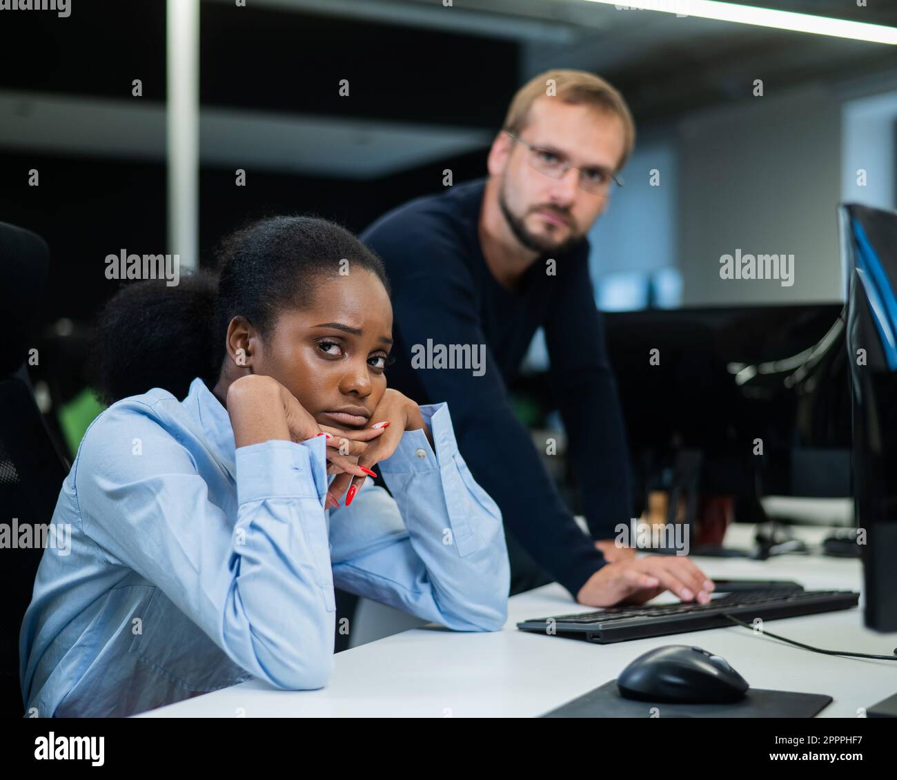 Colleagues look at the monitor and decide working moments. Caucasian ...