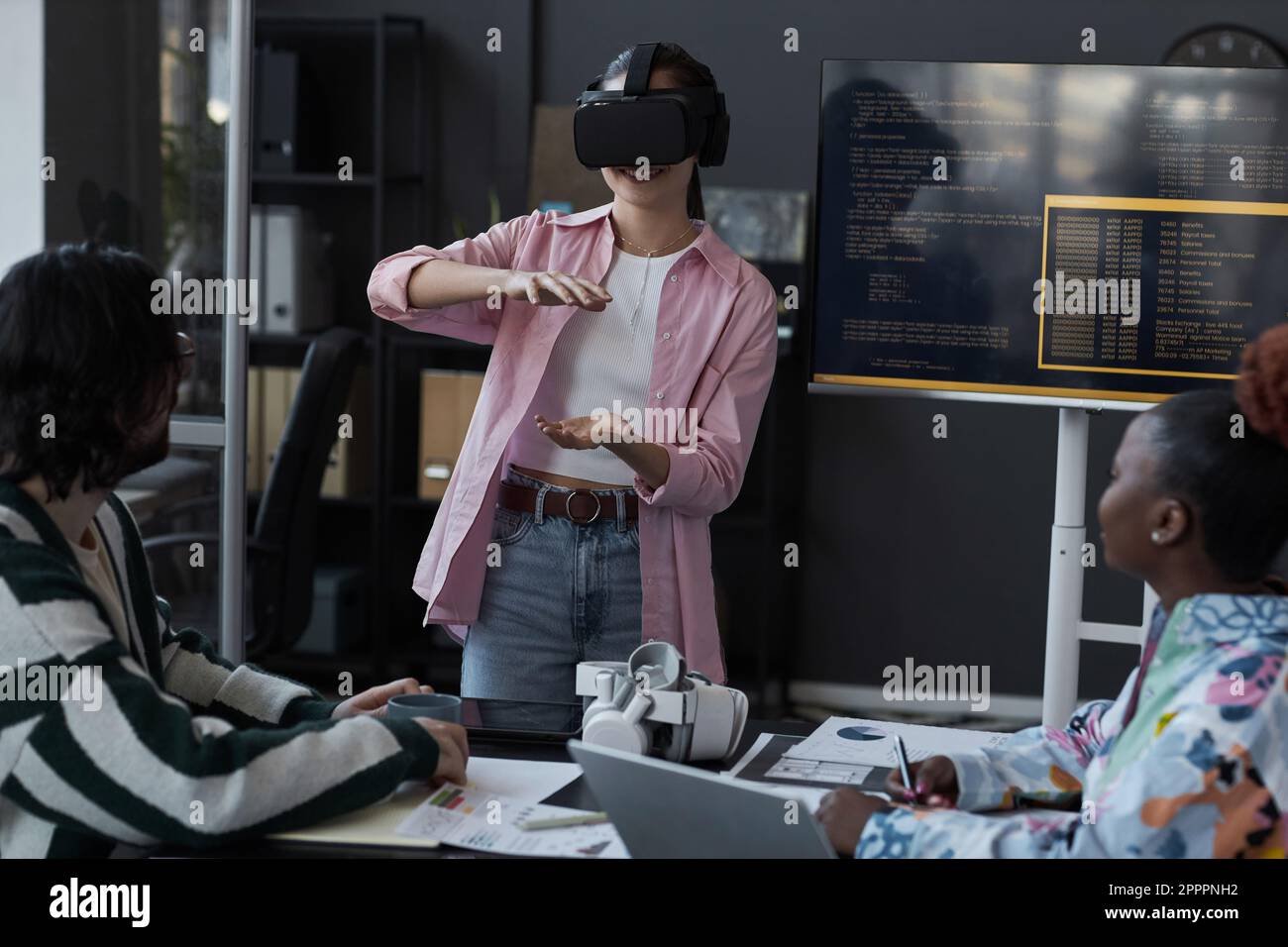 Group of programmers testing new VR glasses during presentation in office Stock Photo