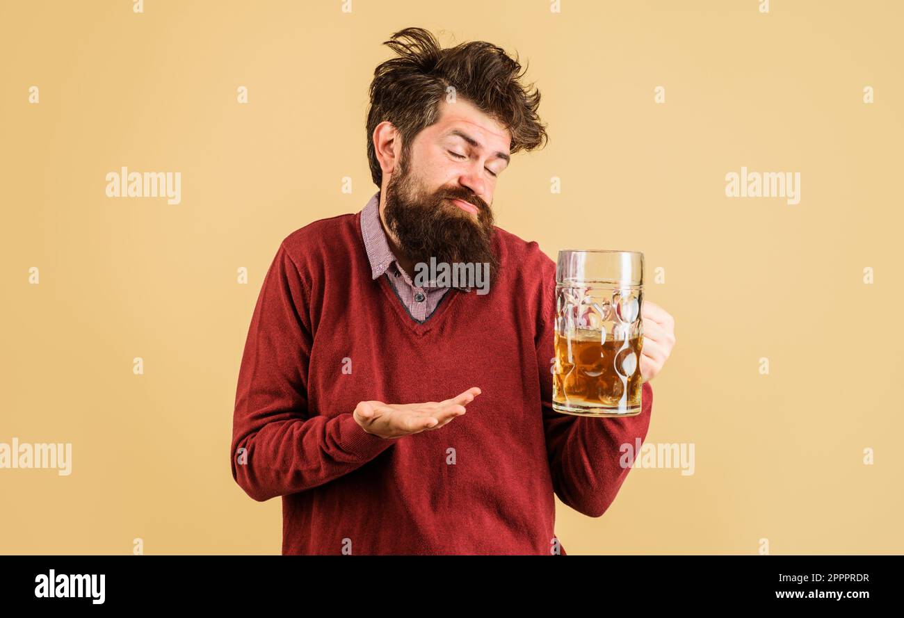 Celebration oktoberfest festival. Drunk man with craft beer mug. Man drinking draught beer at bar or pub. Bearded man with glass of delicious beer Stock Photo