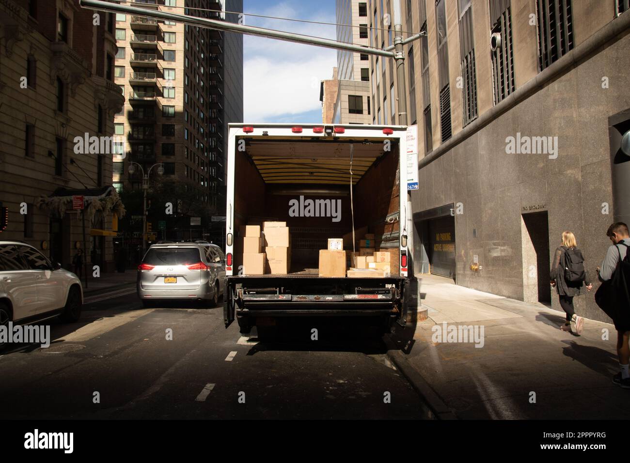 Double parked delivery truck with the back door open in Manhattan New York Stock Photo