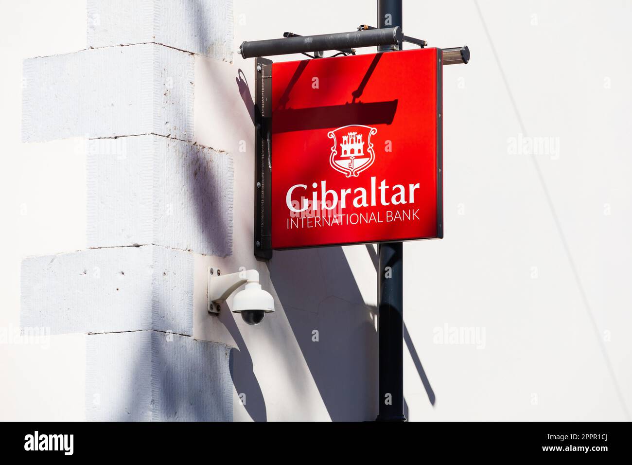 Gibraltar International Bank hanging sign on white building. The British Overseas Territory of Gibraltar, the Rock of Gibraltar on the Iberian Peninsu Stock Photo