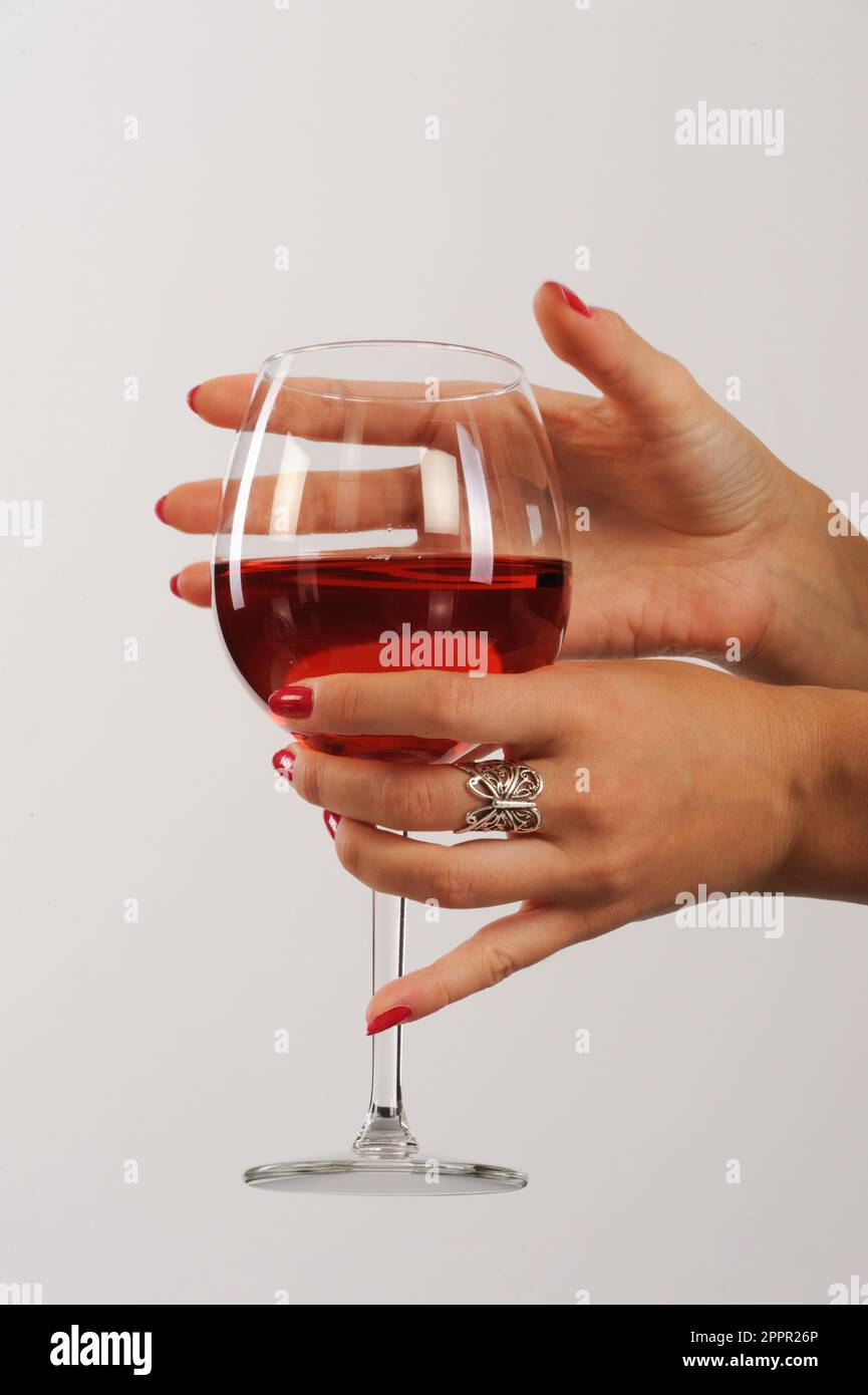 beautiful woman hand holding glass of red wine in a hand on a white ...