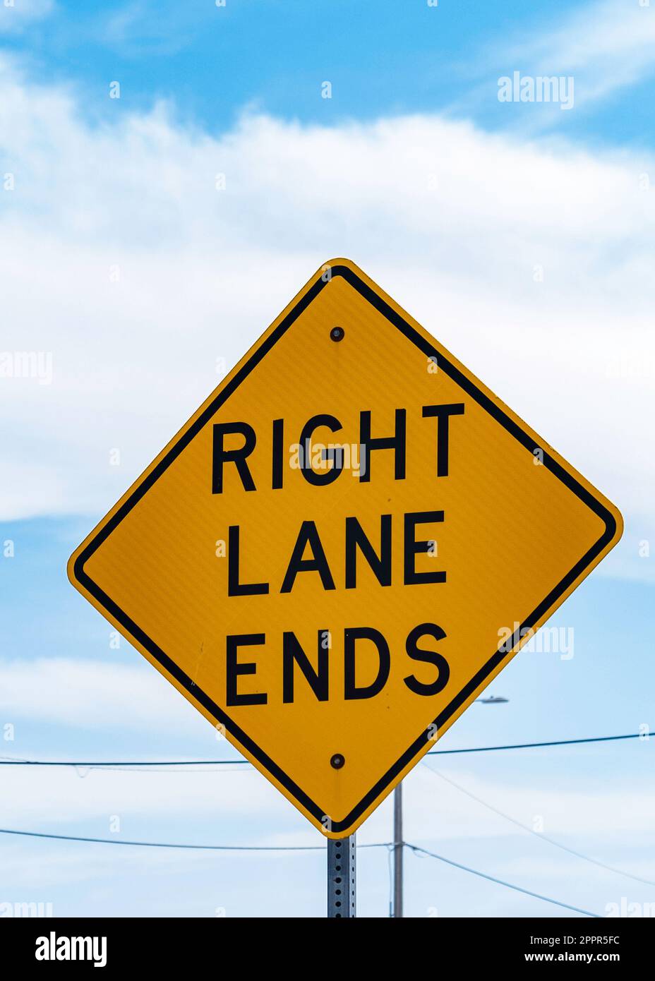 Yellow traffic sign with Right Lane Ends warning. USA. Stock Photo