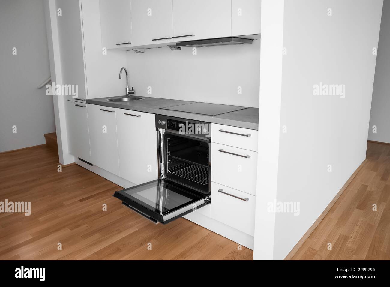 Interior of modern kitchen with white counters, sink and oven Stock ...