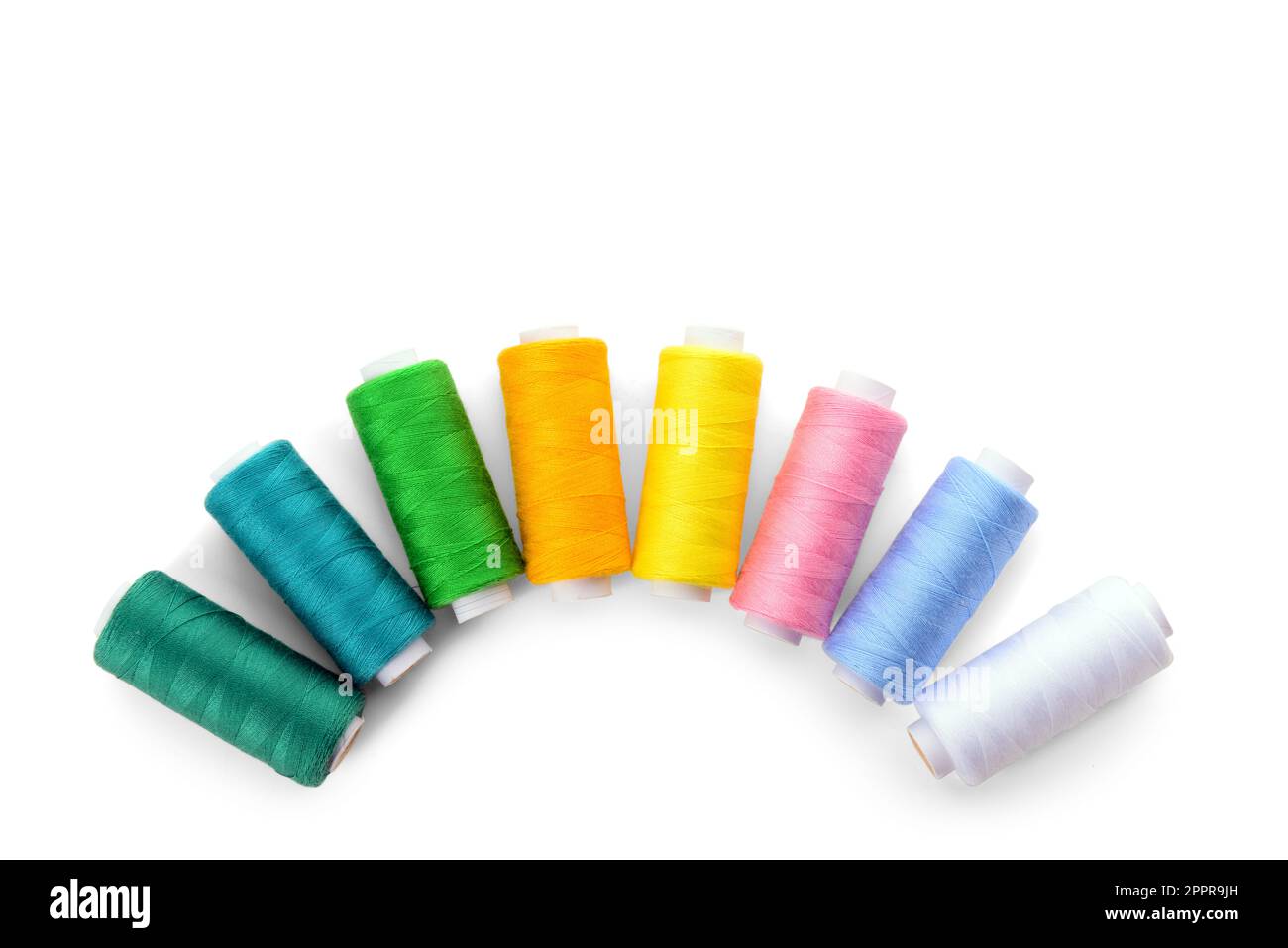 Composition with different thread spools on white background Stock Photo