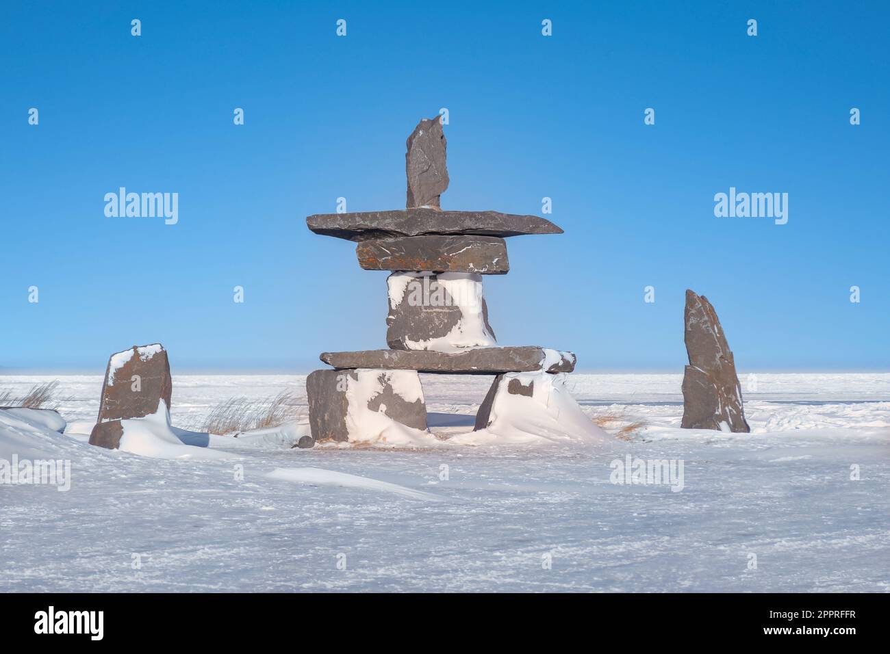 An Arctic cultural landmark known as an Inukshuk, used as navigational aids and communication by First Nations people in the Canadian north. Churchill Stock Photo