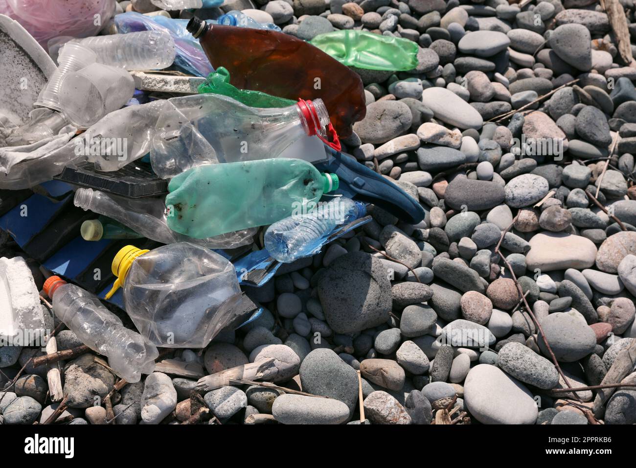 Pile of garbage on stones outdoors, closeup. Environmental Pollution concept Stock Photo