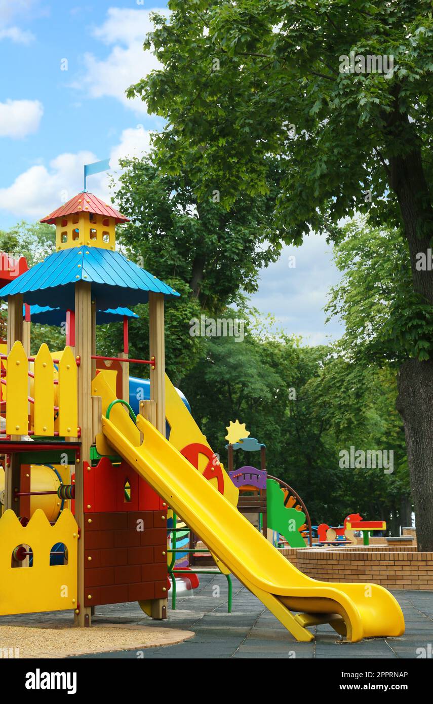 New colorful castle playhouse with slide on children's playground Stock
