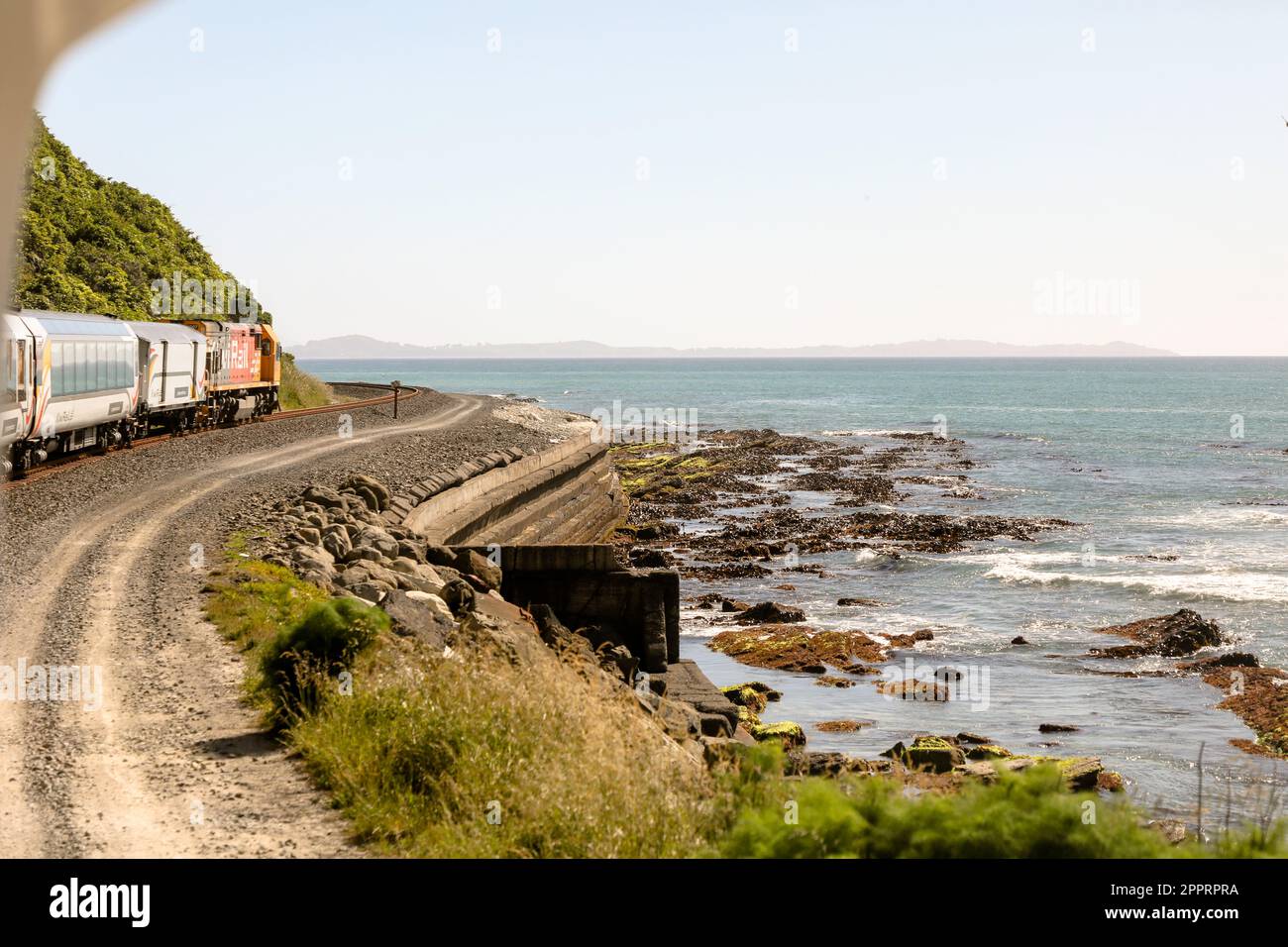 A KiwiRail passenger train from Christchurch plies the rugged Coastal