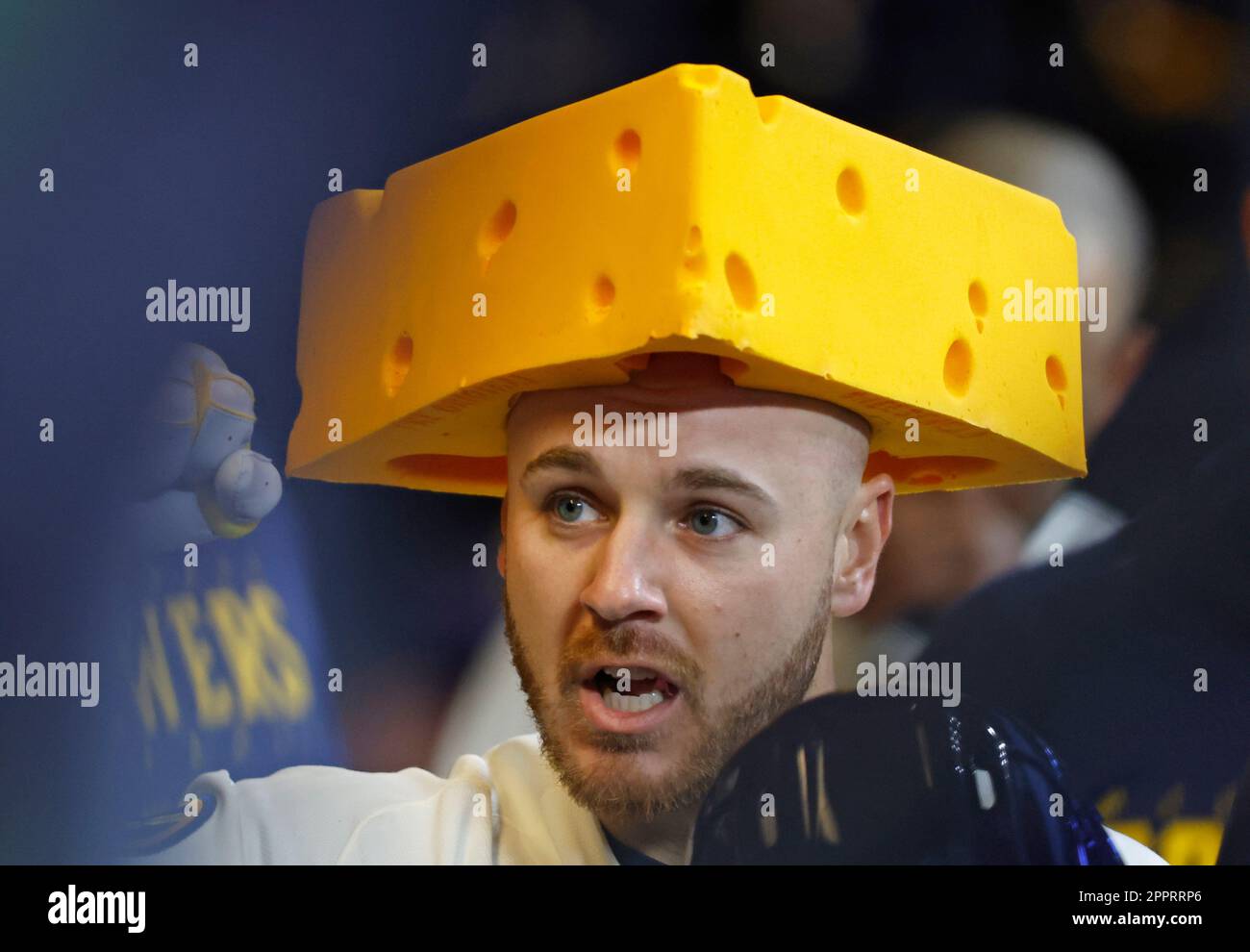 Milwaukee Brewers' Mike Brosseau (10) wears a cheese hat in the dugout