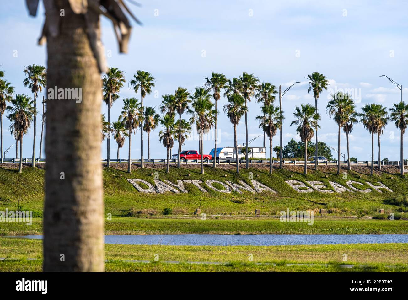 Iconic Daytona Beach lettering beneath a row of palm trees welcoming travelers along I-95 at LPGA Boulevard in Daytona Beach, Florida. (USA) Stock Photo