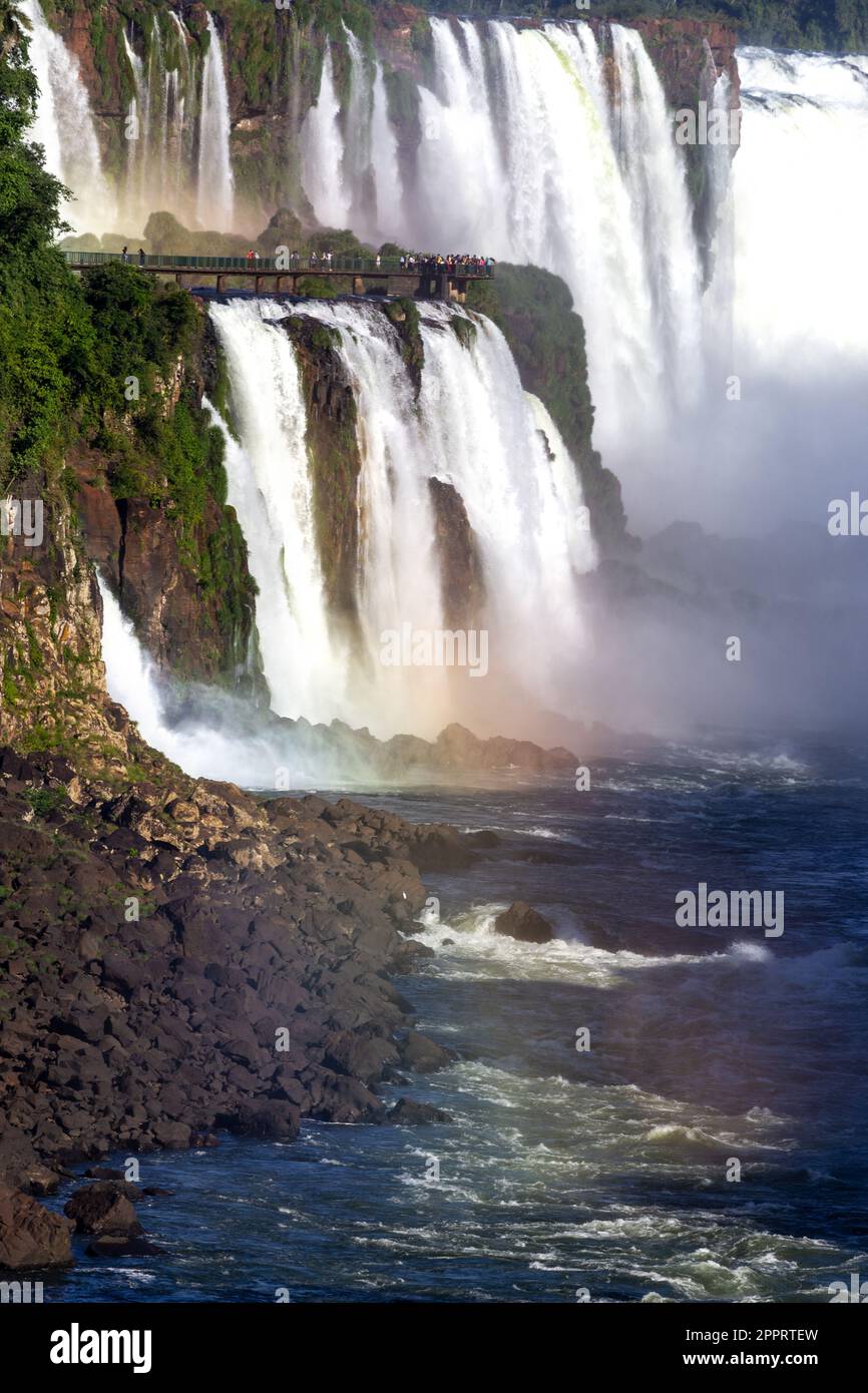 Falling Waterfalls World Famous Iguazu Falls, Giant U-Shapped Parana River Cascades. Garganta Del Diablo Devil's Throat Viewpoint suspended walkway Stock Photo