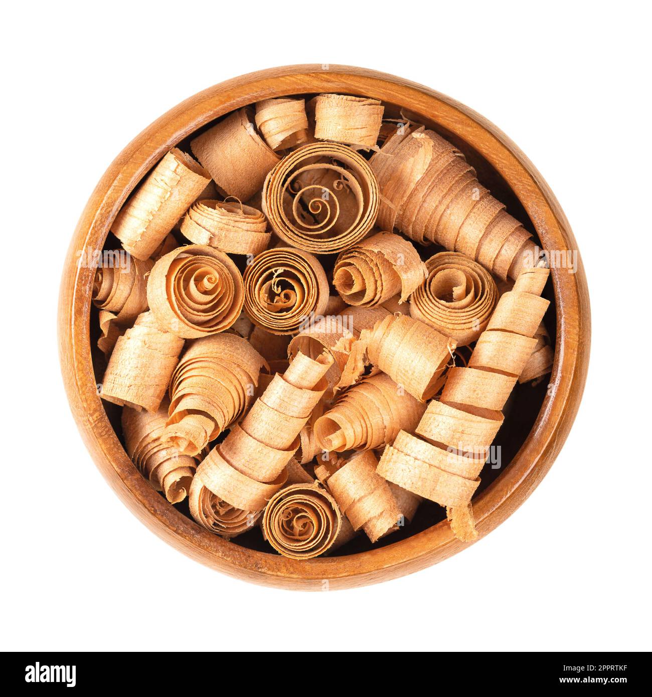 Spiral shaped wood shavings of Swiss pine, in wooden bowl. Pinus cembra, European white pine, with distinctive smell from essential oil pinosylvin. Stock Photo