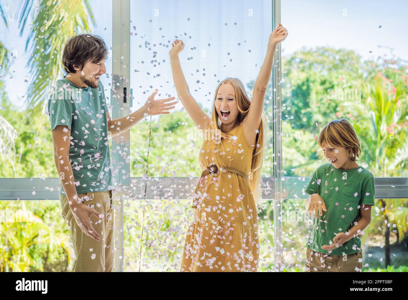 It's a girl. Expectant parents mother, father and their elder son are ...