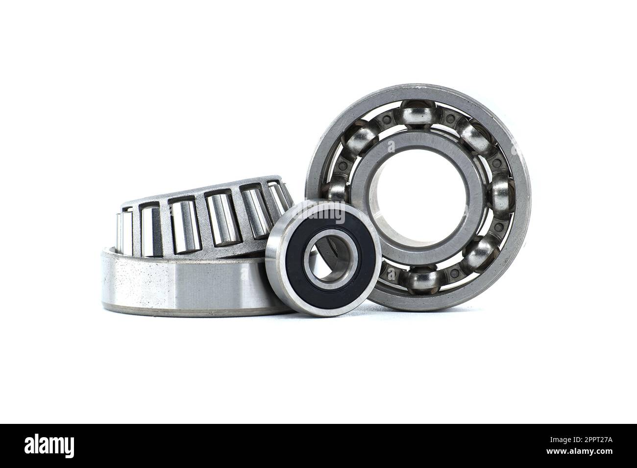 Ball bearings and tapered roller bearing isolated on white background
