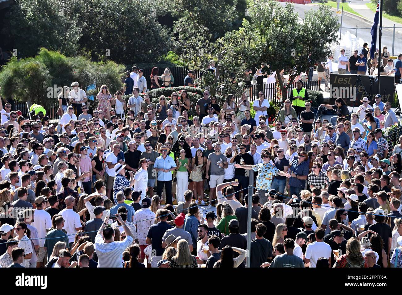 A large crowd is seen playing TwoUp during ANZAC Day at Harbord