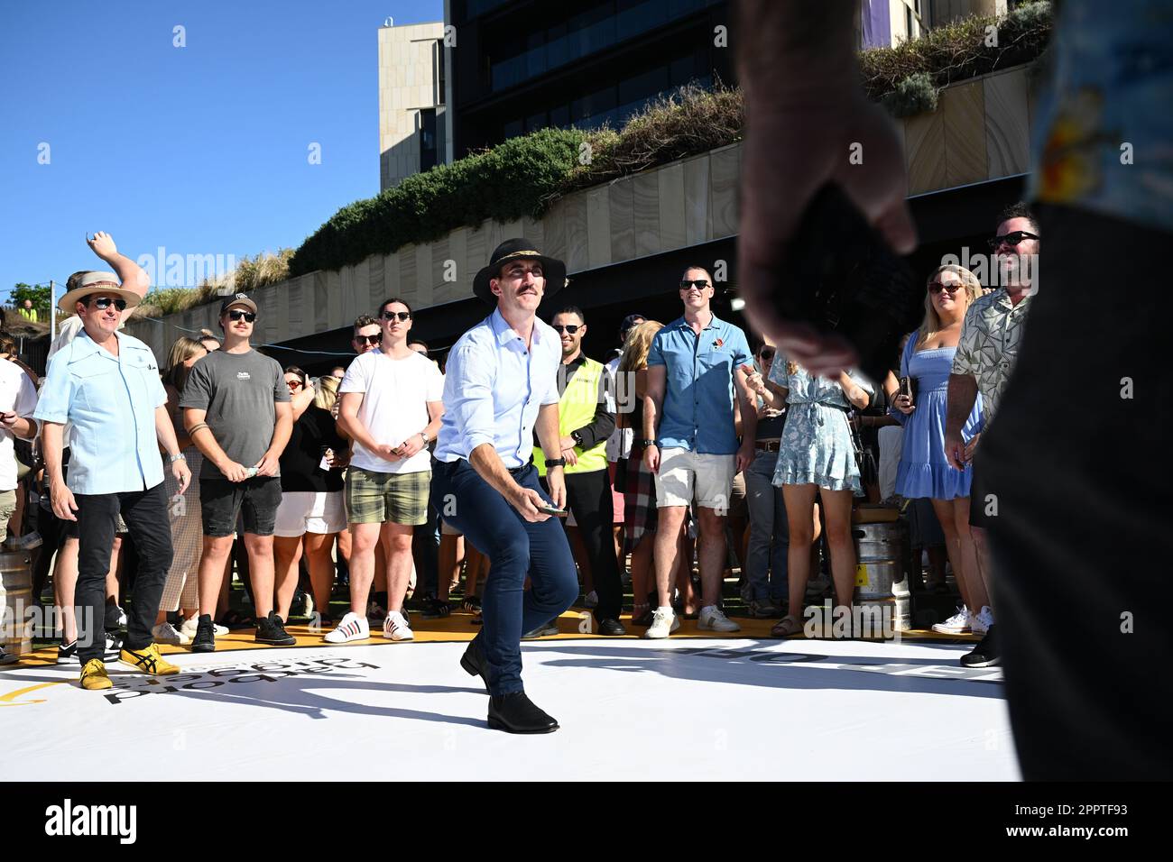 A large crowd is seen playing TwoUp during ANZAC Day at Harbord