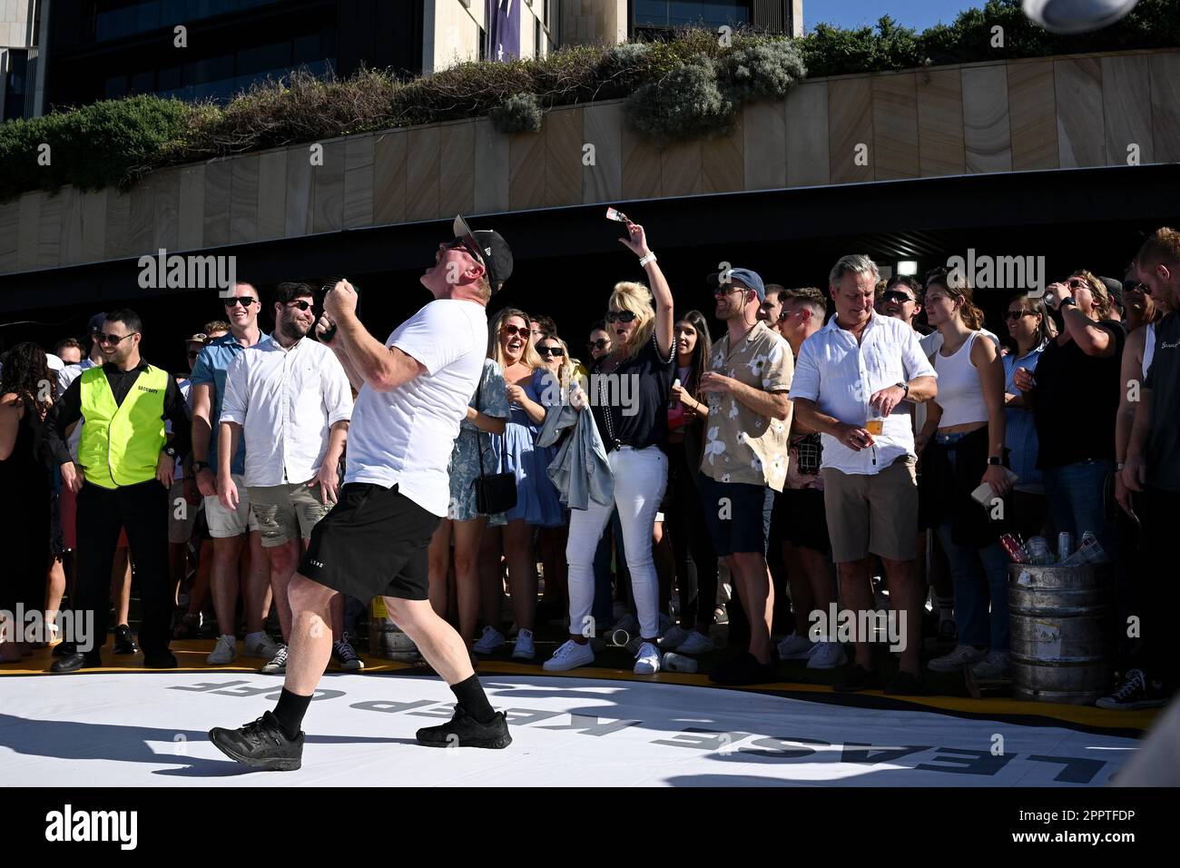 A large crowd is seen playing TwoUp during ANZAC Day at Harbord