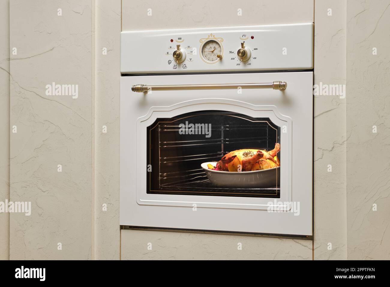 Process of baking food in oven. Whole chicken in ceramic casserole