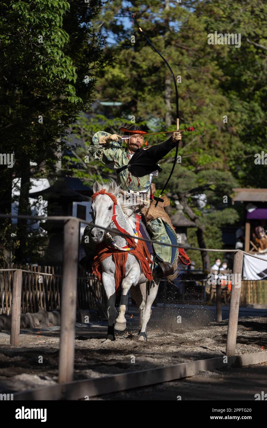 Yabusame (Japanese horseback archery) archer aims on target. 65th
