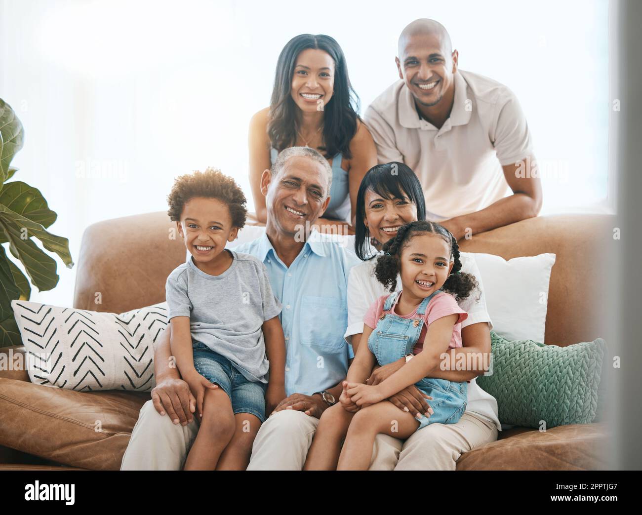 Portrait love and big family on a couch smile and bonding with