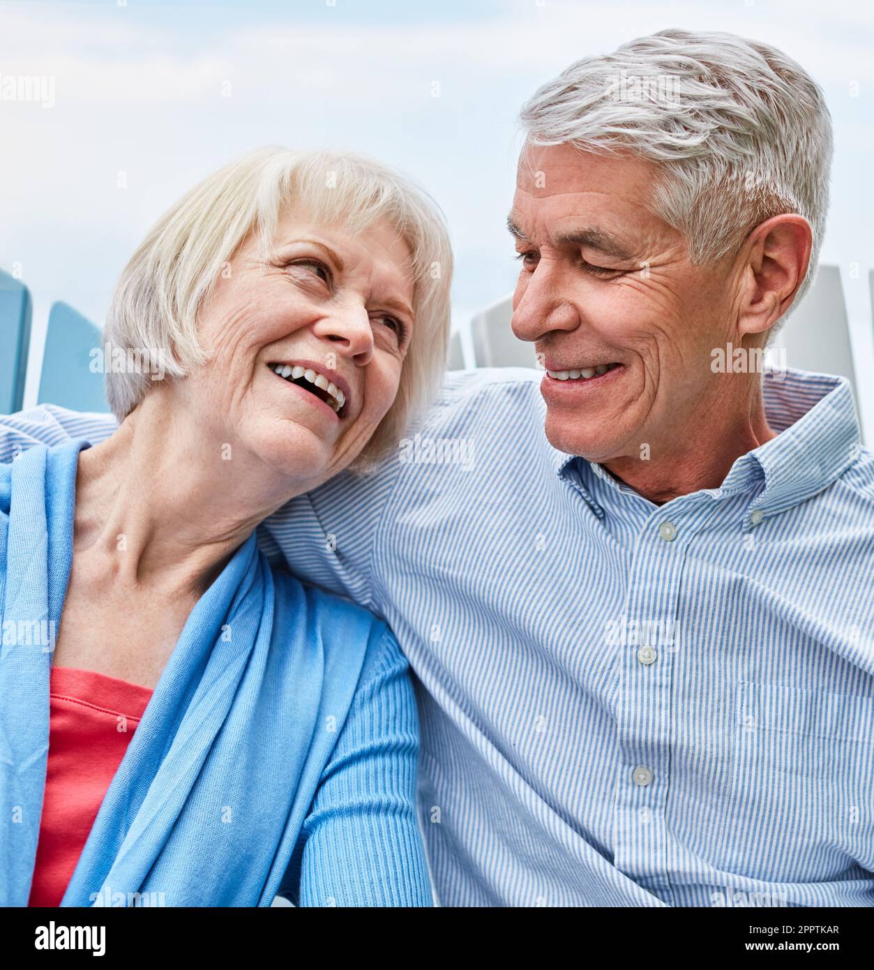 Ive always loved you, I always will. an affectionate senior couple relaxing on chairs together outside. Stock Photo