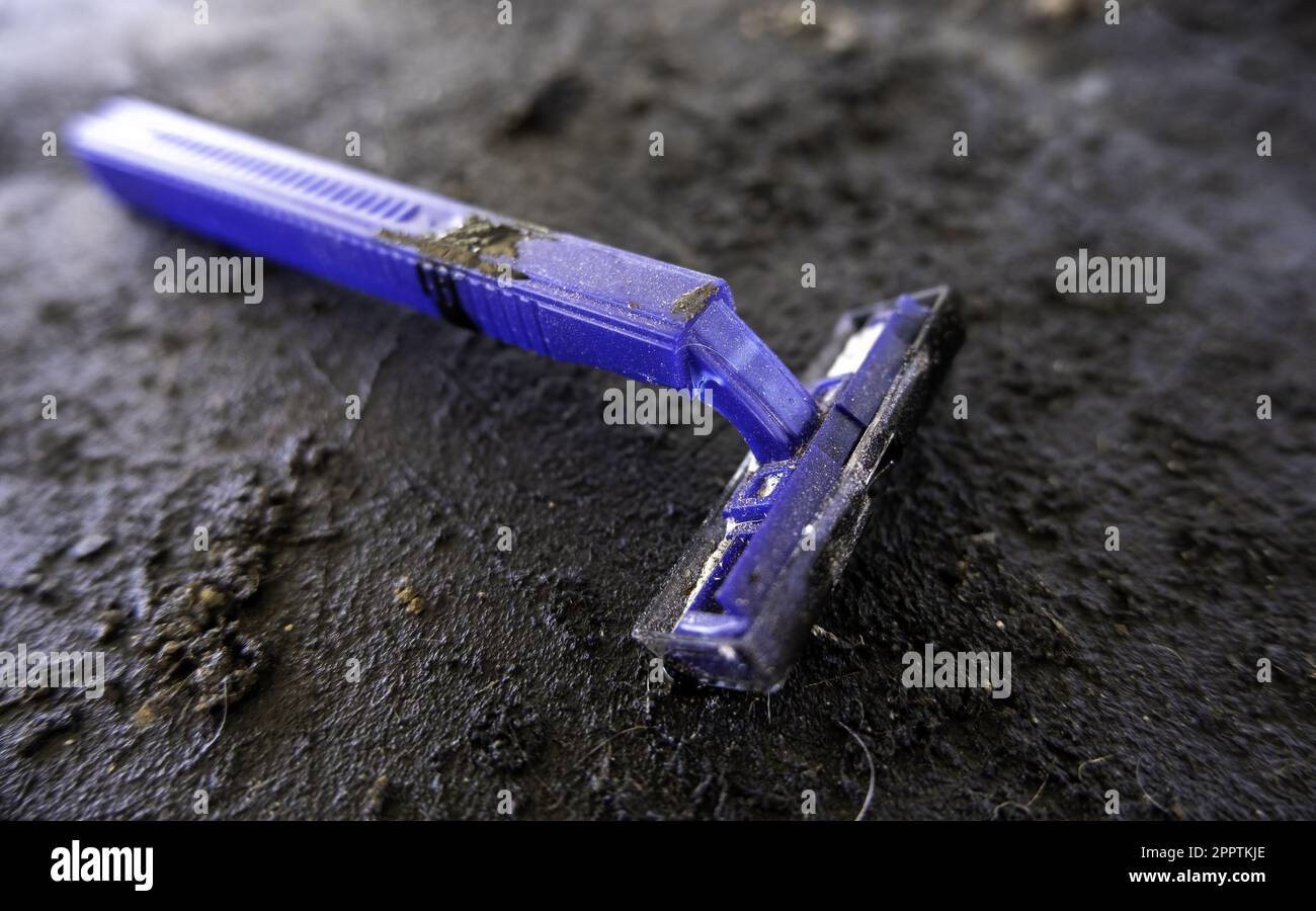 Old and worn out disposable razor Stock Photo