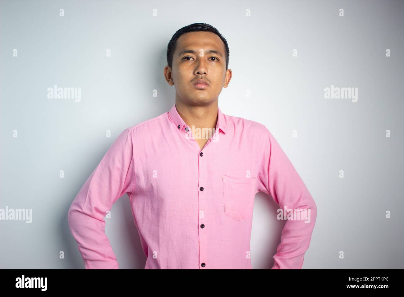 Asian young man wearing pink shirt with expression Stock Photo Alamy