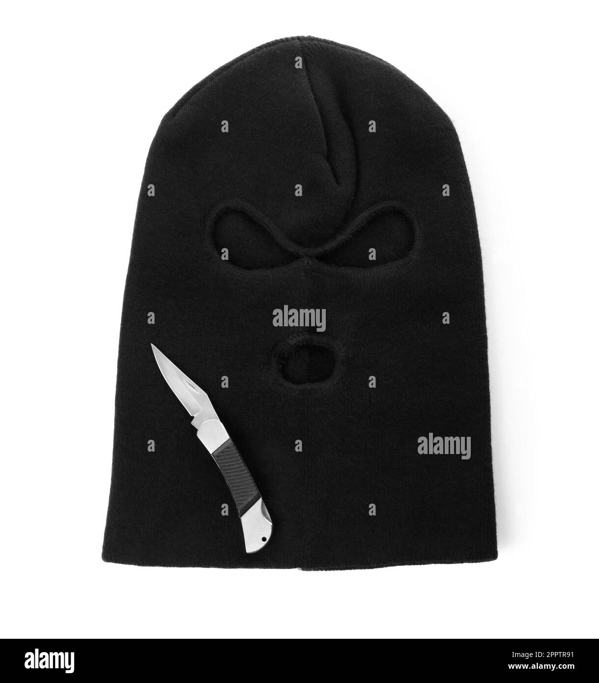 Black knitted balaclava and knife on white background, top view Stock
