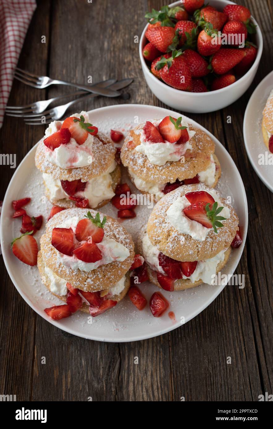 Pastry with strawberries. Traditional strawberry shortcake. Served on wooden table from above. Stock Photo