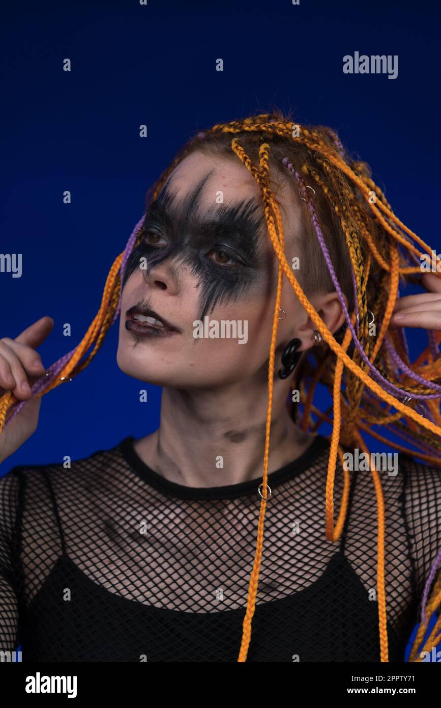 Dramatic portrait of young female with spooky stage makeup painted on face  and dreadlocks hairstyle 32500542 Stock Photo at Vecteezy