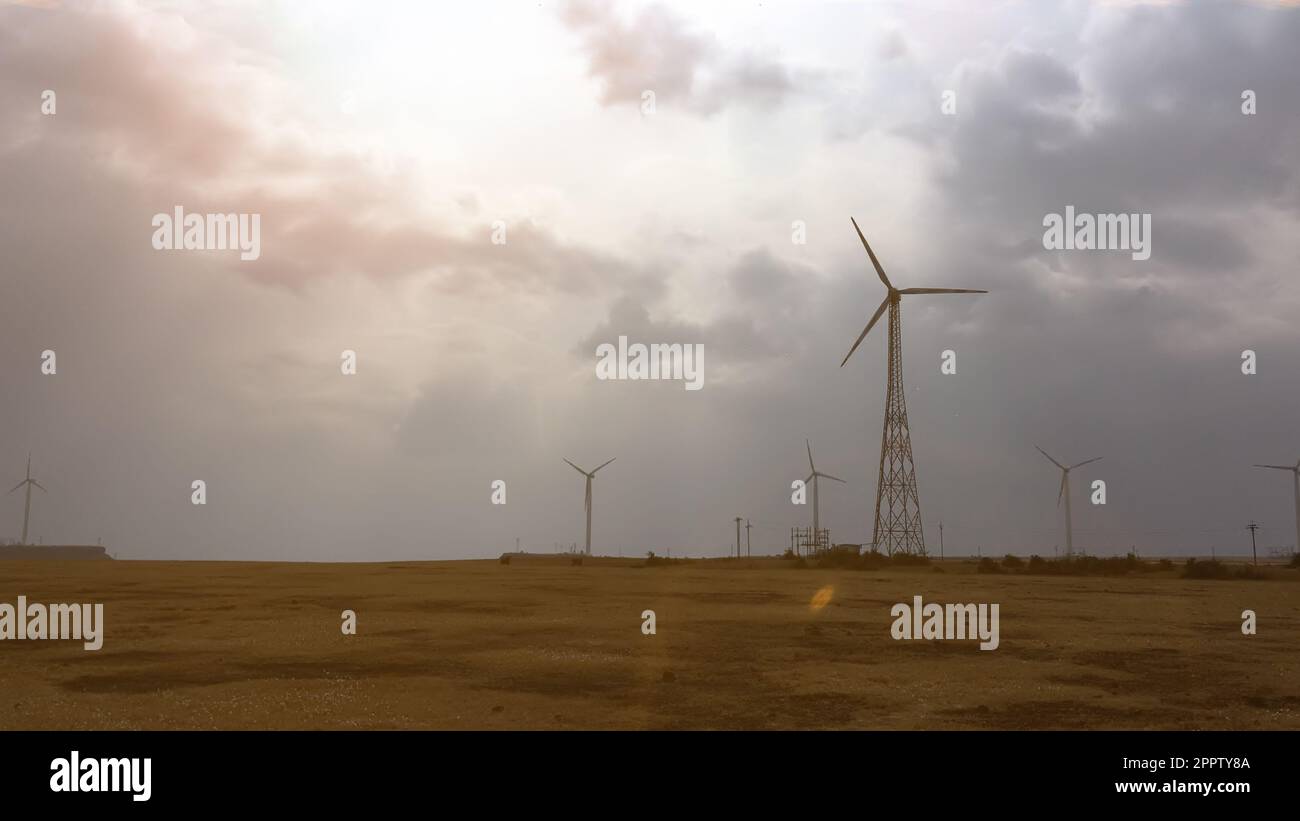 Windmill generating energy in sunny day in silhouette Stock Photo - Alamy