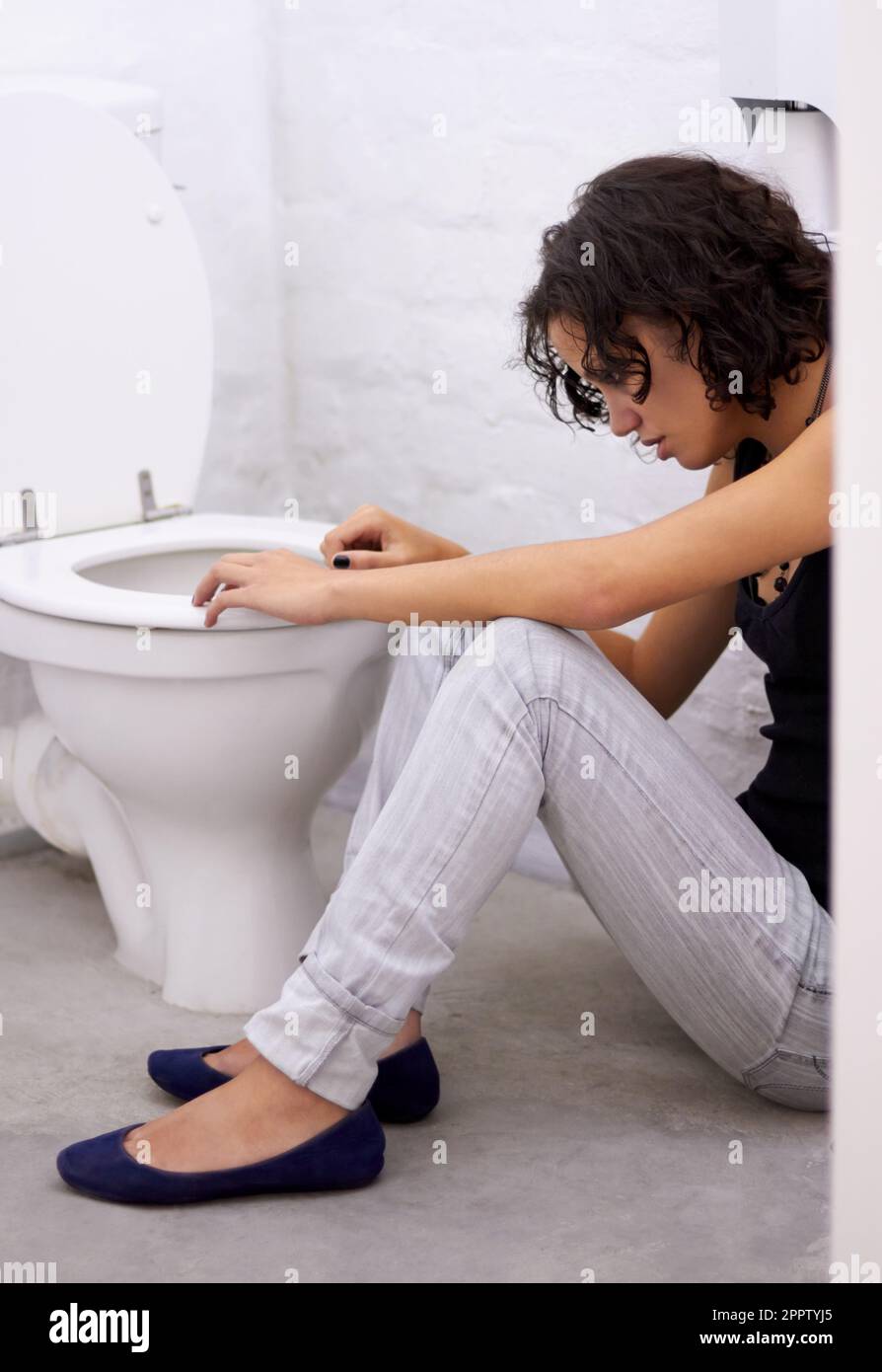 Bathroom, sick and woman on a floor suffering from anorexia, depression
