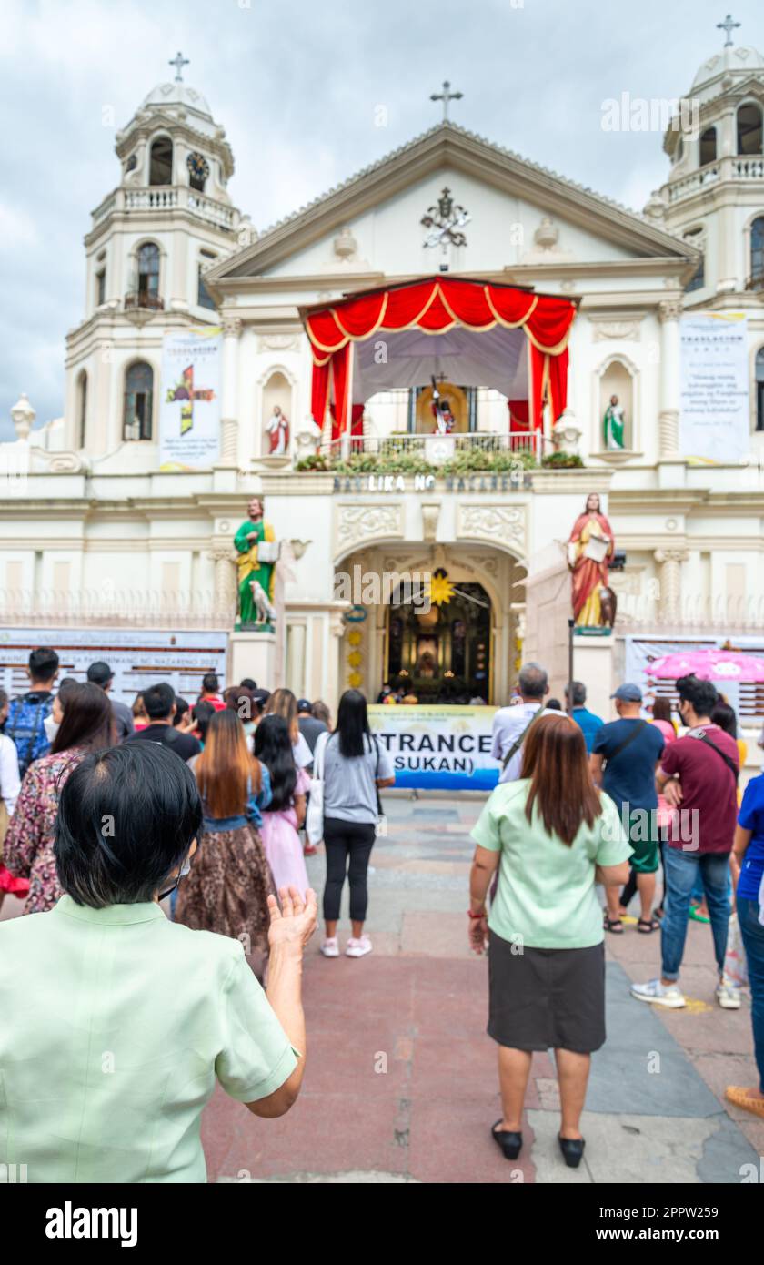 Manila,The Philippines-Jan 07 2023: People gather for prayers outside Quiapo Church,the day before the Traslación,or procession walk,to commemorate th Stock Photo