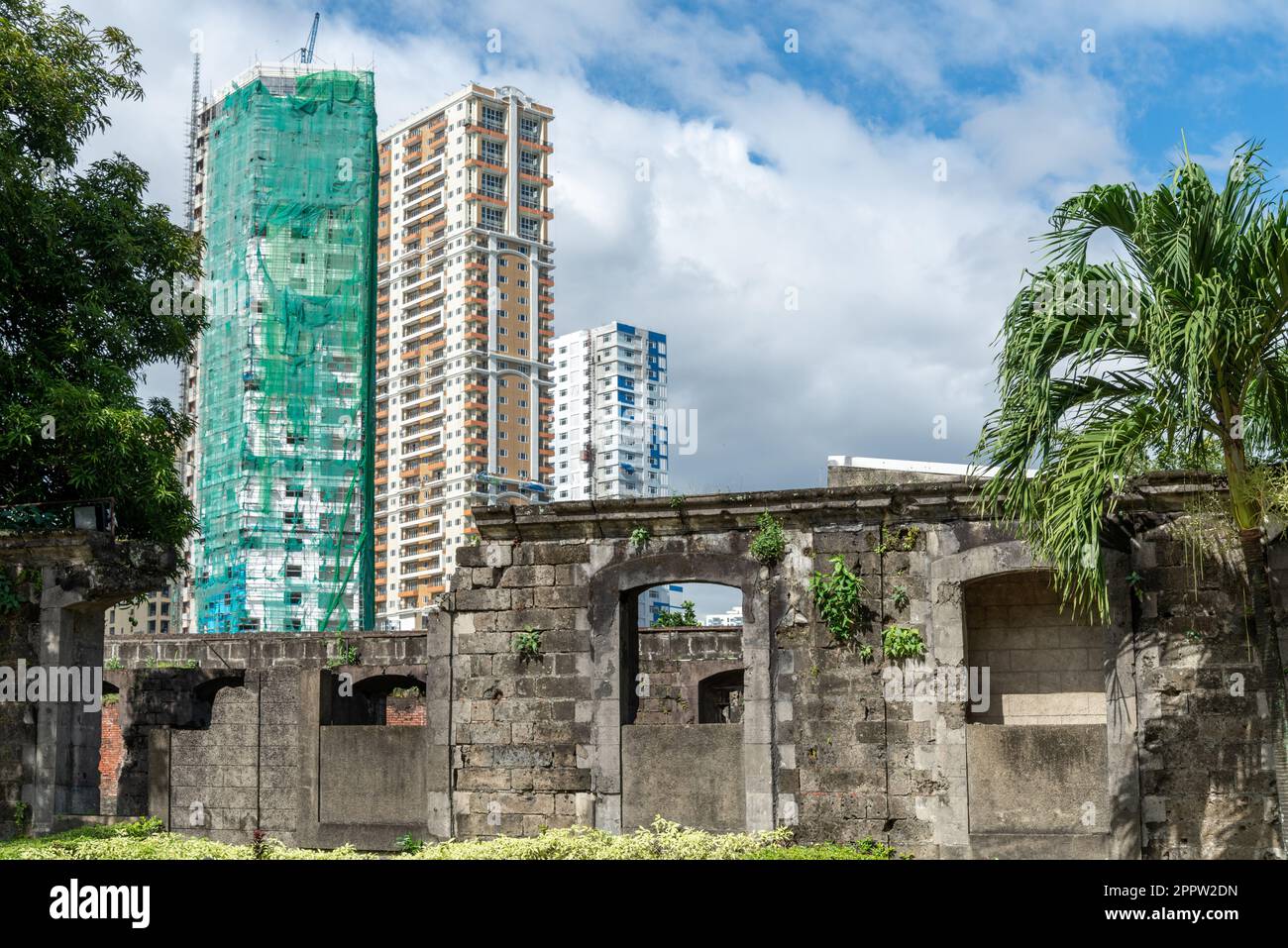 Remains of Fortress walls and arched doorways,juxtaposed with tall contemporary,residential blocks,outside the walled,old city area,in the distance,wi Stock Photo