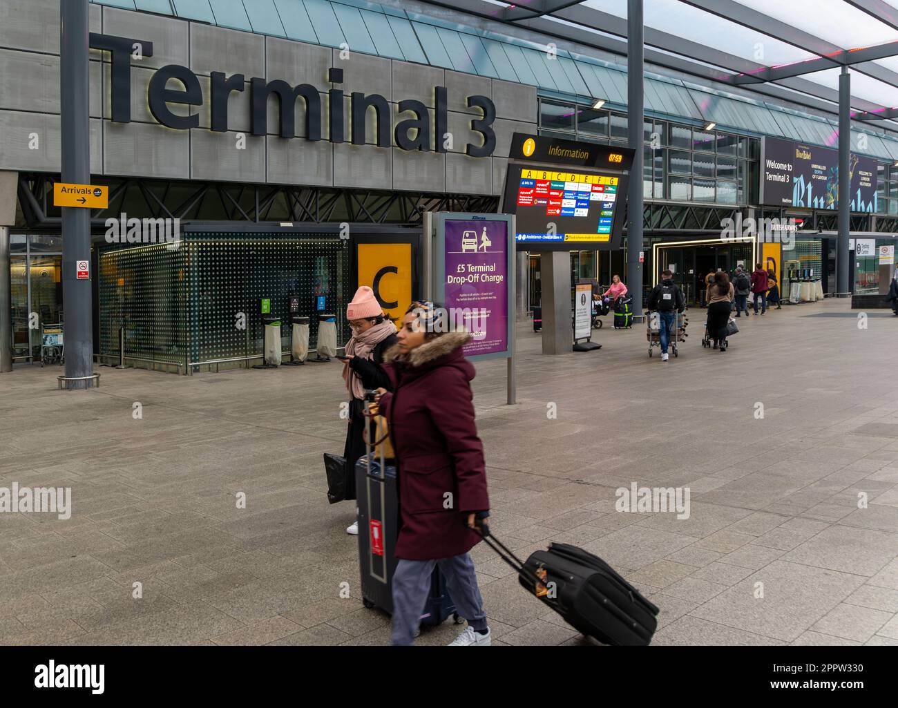 Passengers with luggage outside Terminal 3 building, London Heathrow