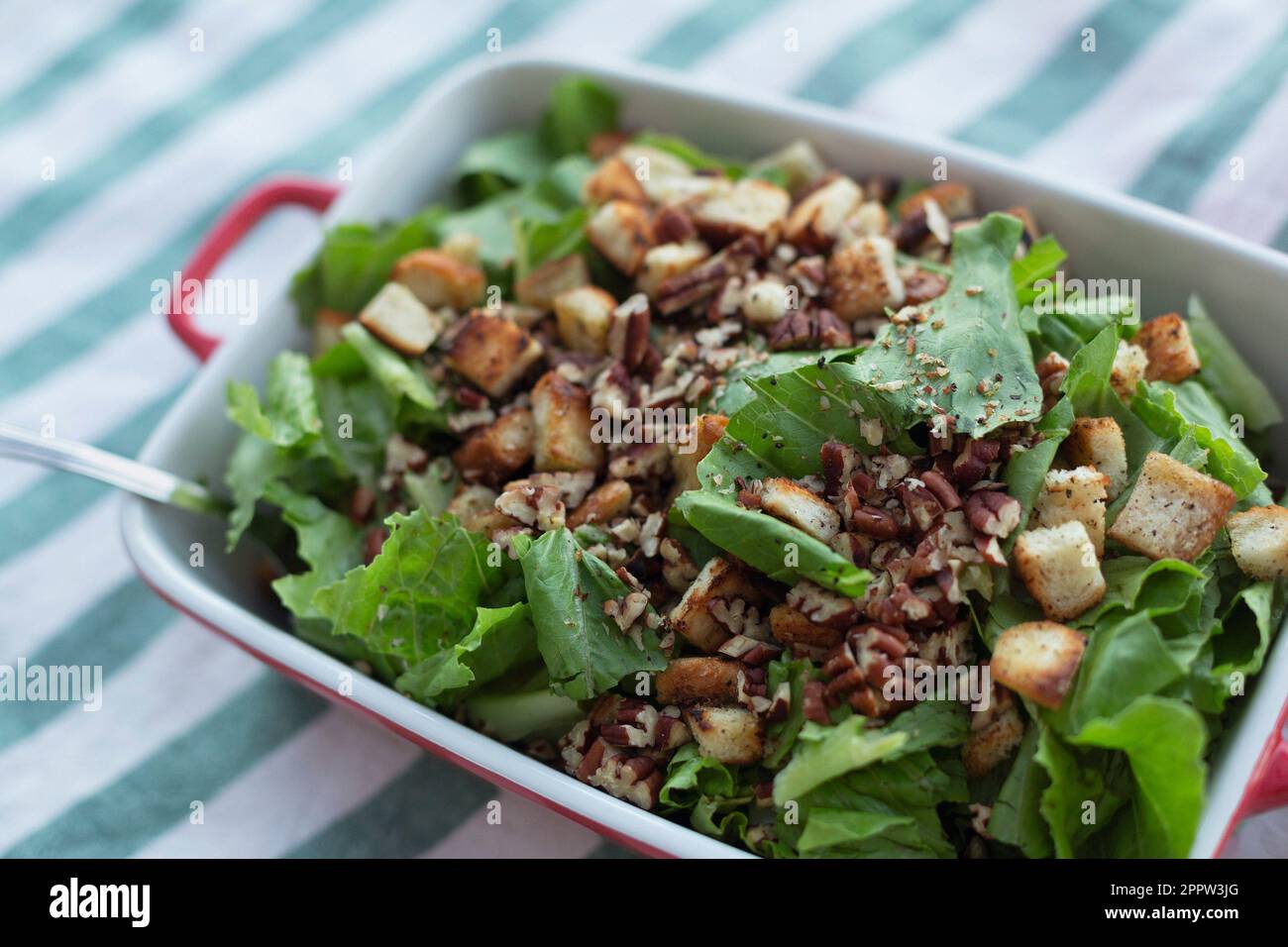 Still life close up healthy, fresh salad with walnuts and croutons Stock Photo