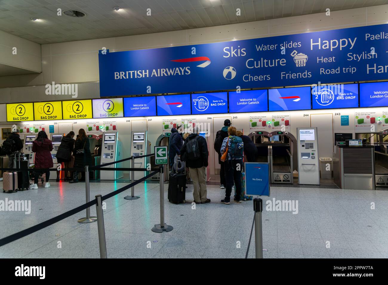 Passengers using British Airways automatic bag drop facilities inside