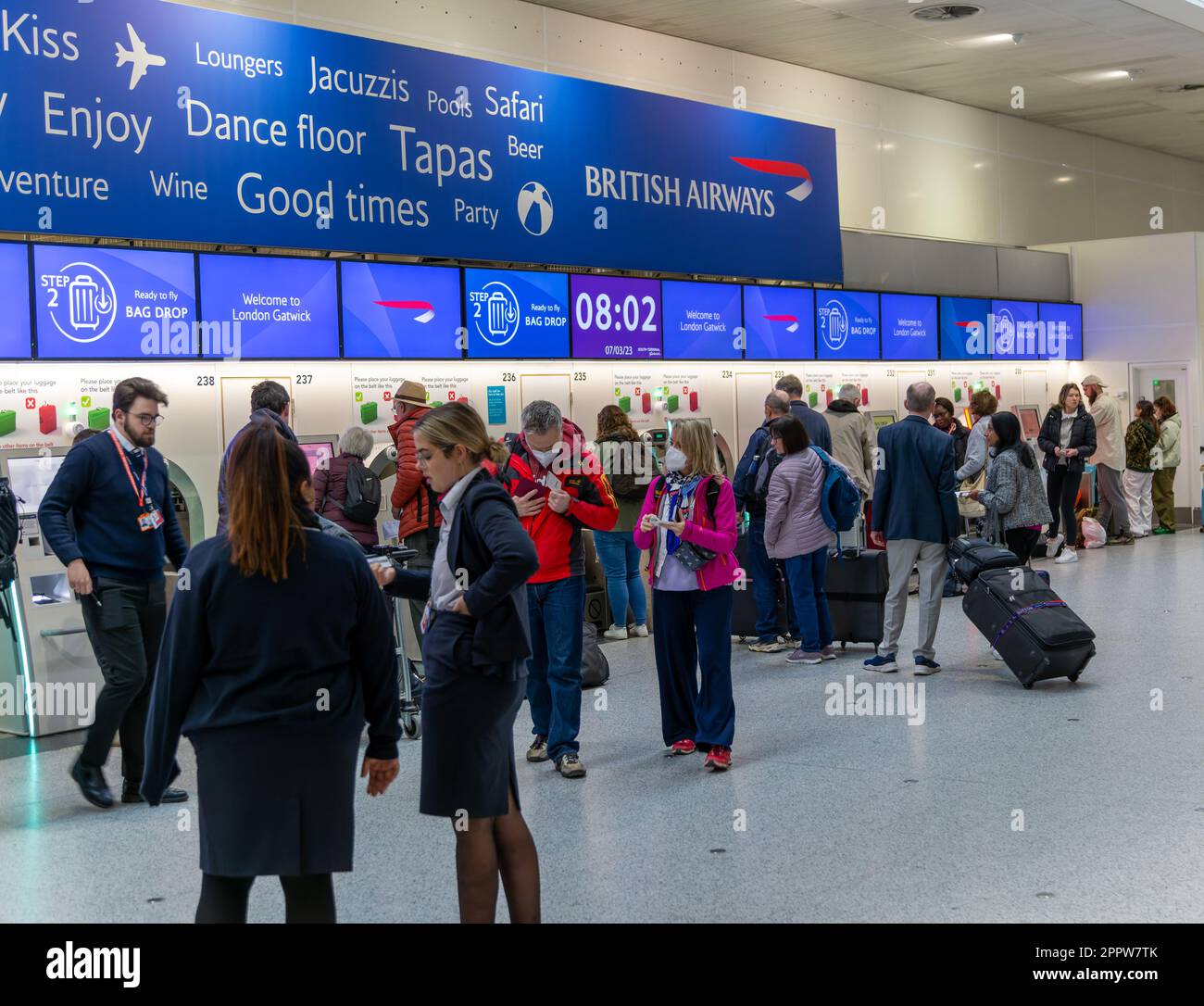 Passengers using British Airways automatic bag drop facilities inside