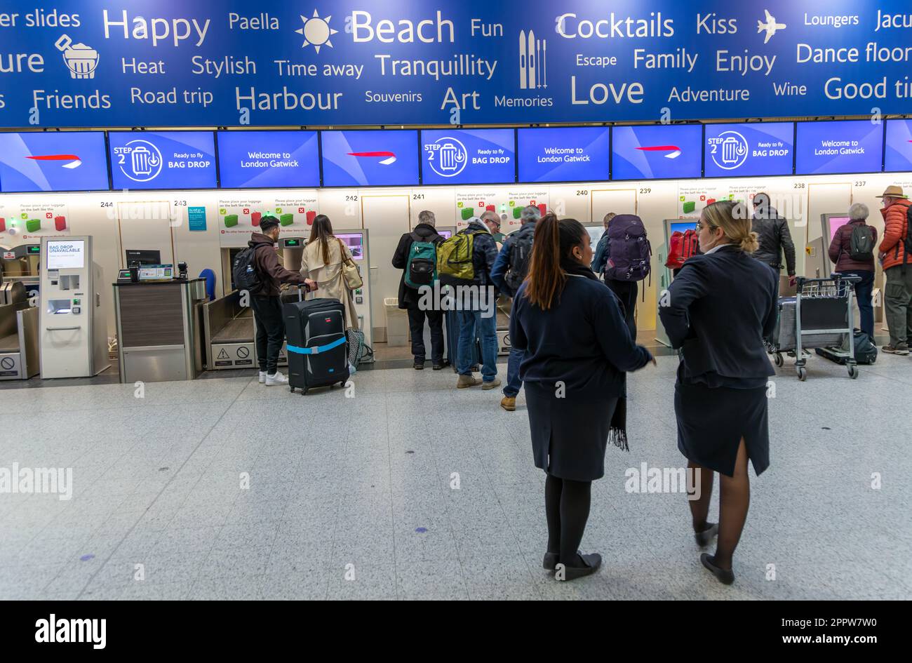 Passengers using British Airways automatic bag drop facilities inside